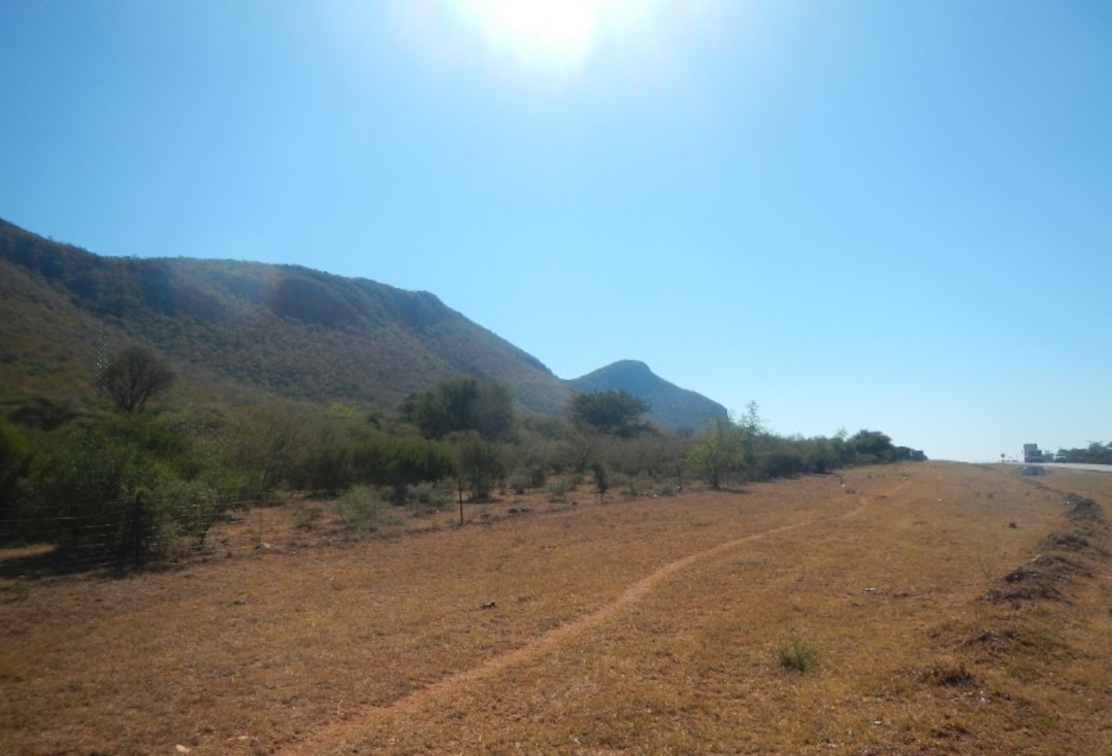 Scenic landscape near Otse, Botswana, showcasing rolling hills and acacia trees